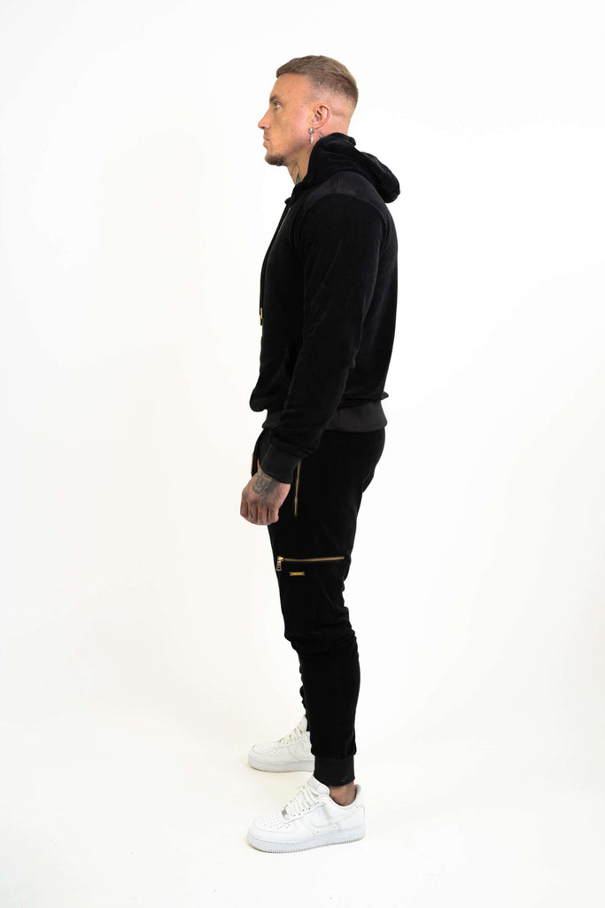 black velour sweatpants and hoodie